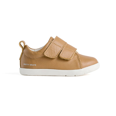 Side view of baby shoes with velcro strap. Colour tan.